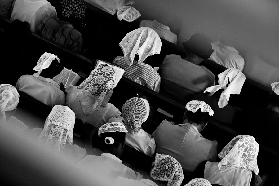 Catholic believers pray in pew during the Sunday mass in Delmas, Port-au-Prince, Haiti.