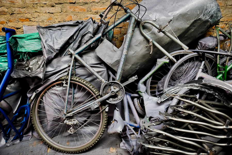 A broken old bicycle, together with bicycle frames, is seen in a small scale bicycle factory in Cali, Colombia.