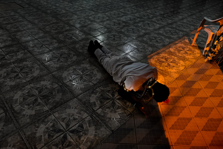 A Candomblé follower prays during an Afro-Brazilian religious ritual in the temple (terreiro) in Bahia, Brazil.