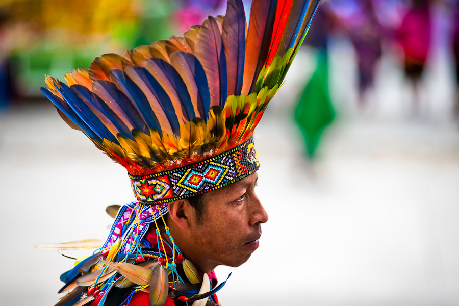 A Colombian Kamentsá native, wearing a colorful feather headgear, takes part in the Carnival of Forgiveness, a traditional indigenous celebration in Sibundoy, Colombia.
