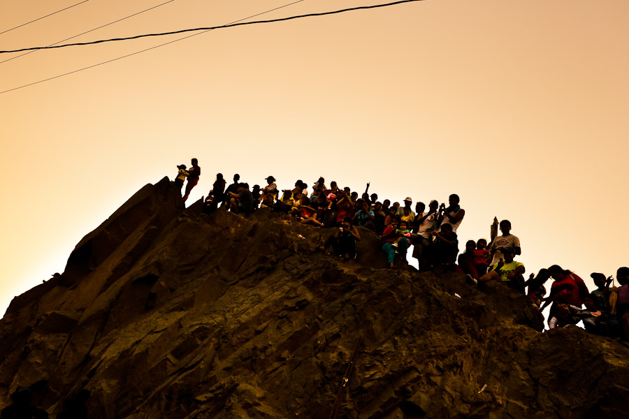Crowds of catholic followers watch the Good Friday procession on the hill of San Cristobal during the Holy week in Lima, Peru.