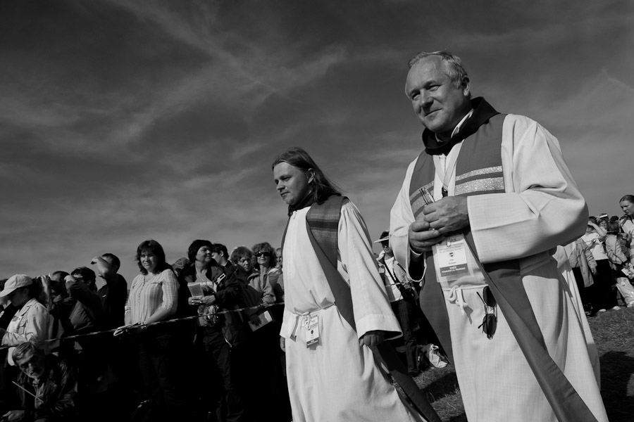 Czech catholic priests walk among the 50,000 believerss to give communion at the end of the mass celebrated by the Pope Benedict XVI.