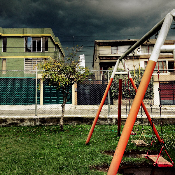 A children's swing is seen at the playground while a usual afternoon storm approaches in Quito, Ecuador.