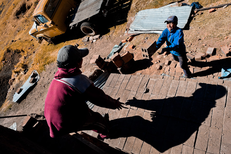 Peruvian boys pile raw bricks aside a kiln at a brick factory in the outskirts of Puno, Peru.