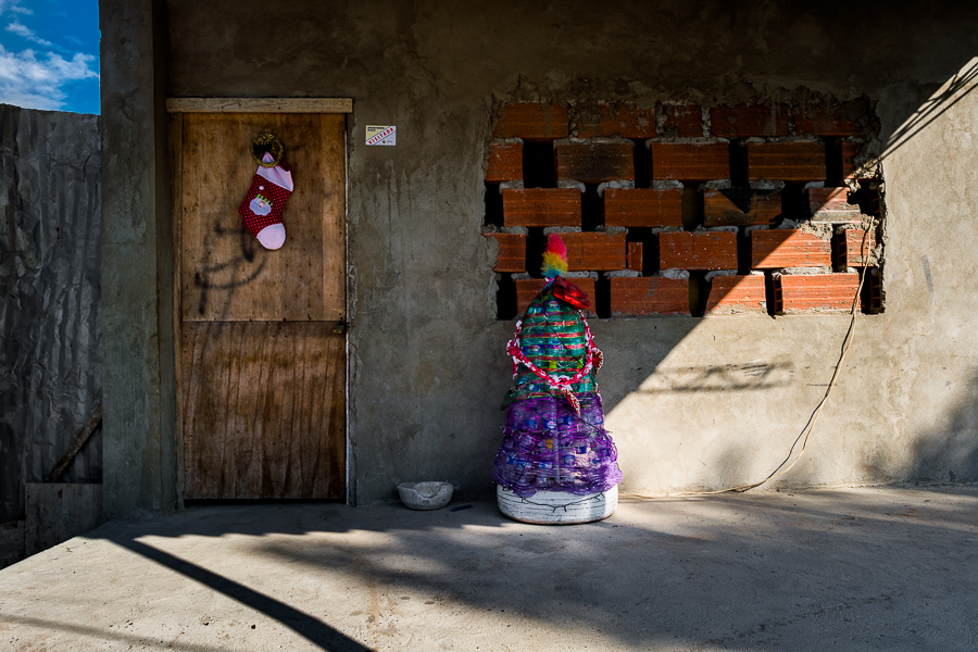 A Christmas tree, made of recycled materials and cheap decorative fabrics, is seen in front of a family house in Olaya Herrera, a lower social class neighborhood in Cartagena, Colombia.