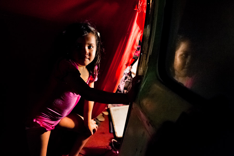 A Salvadorean girl, dressed up as a dancer, enters in the trailer before a performance at the Circo Brasilia, a family run circus travelling in Central America.