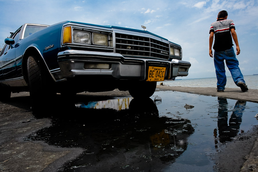 An American classic car from 1970s parked on the bank of the lake Maracaibo
