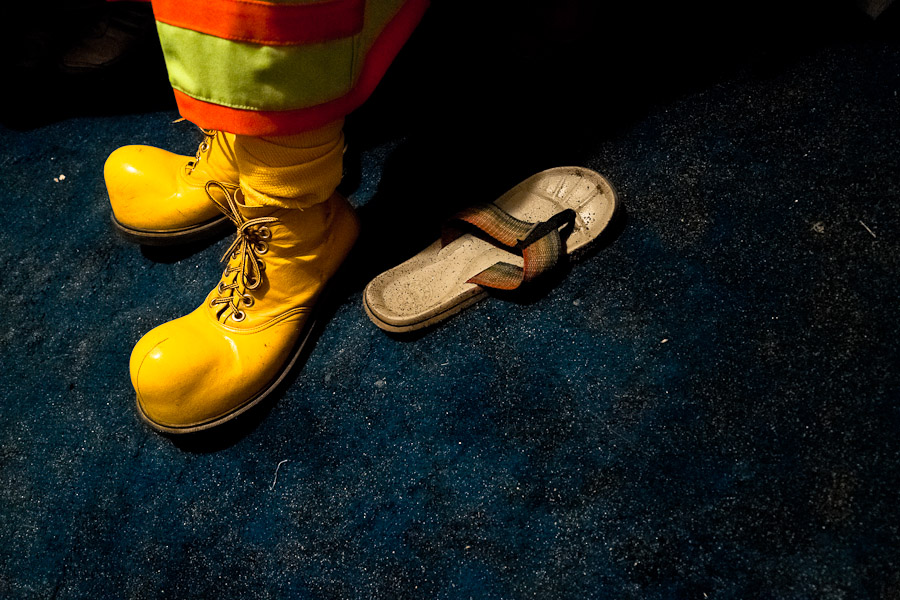 A Colombian man wears the yellow clown shoes before a performance.