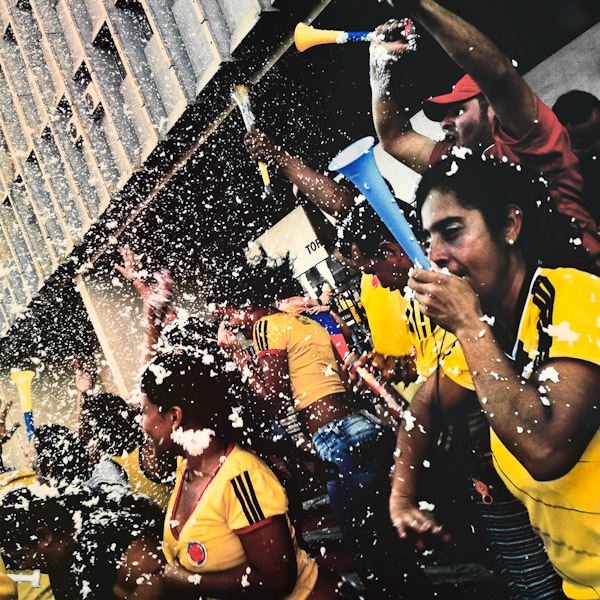 Colombia football fans celebrate a goal while watching the match between Colombia and Uruguay at the FIFA World Cup 2014, in a park in Cali, Colombia.