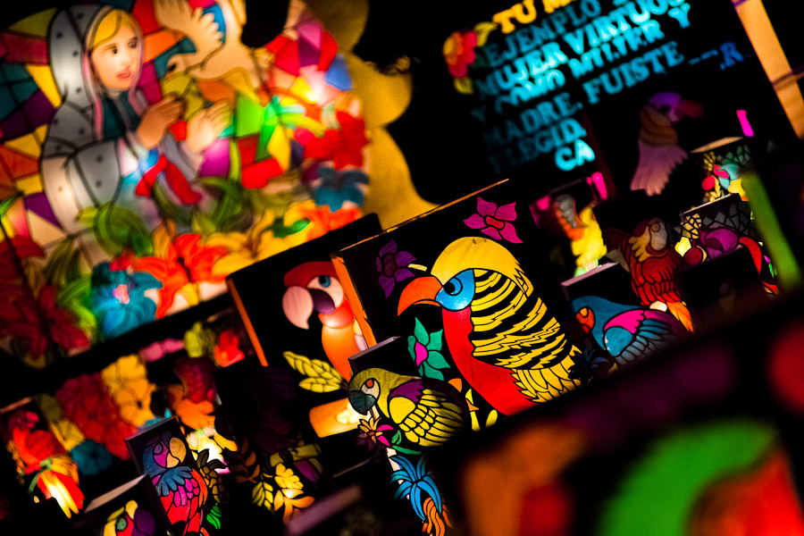 Colorful paper lanterns, depicting birds from tropical rainforests of Amazonia, are seen shining on the street during the annual Festival of Candles and Lanterns in Quimbaya, Colombia.
