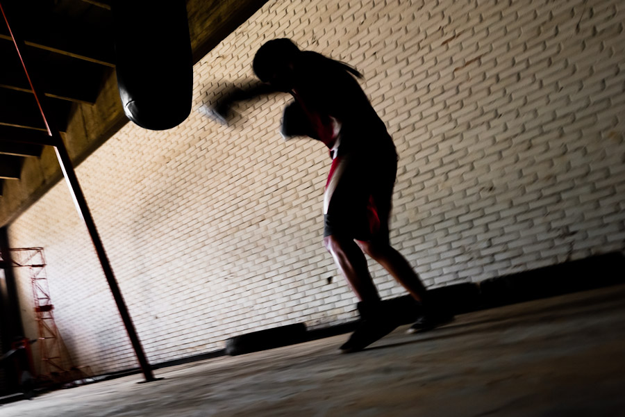 Geraldin Hamann, a young Colombian boxer, practices with punching bag in the boxing gym in Cali, Colombia.