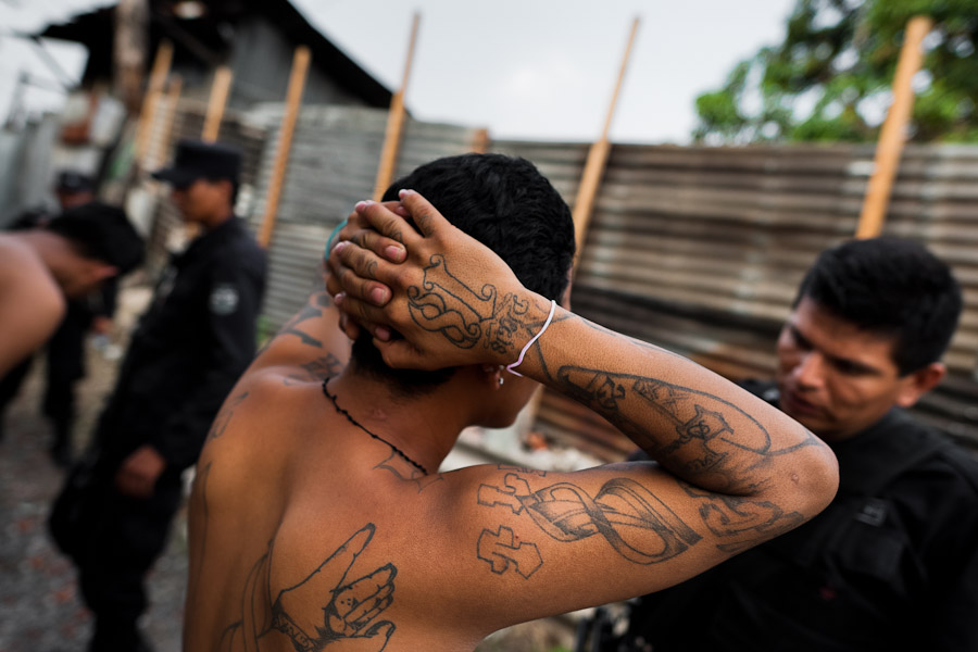 The Barrio 18 gang members are detained by the police officers from the special emergency unit (Halcones) in a gang neighbourhood of San Salvador, El Salvador.