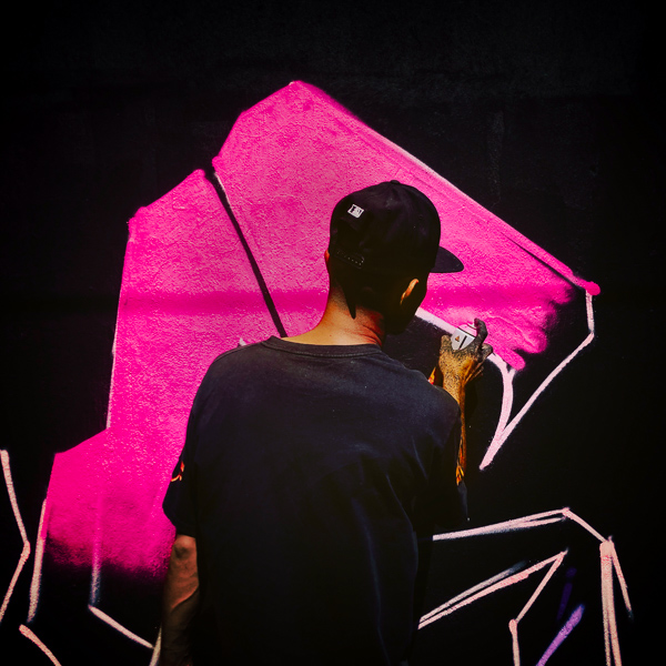A Mexican street artist paints graffiti on the wall of a cemetery during a graffiti event in Guadalajara, Mexico.