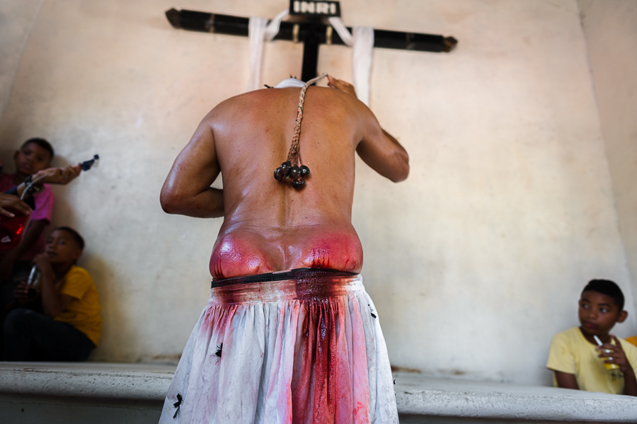 An Afro-Colombian man performs a self-punishment religious ritual during the Holy Week procession on Good Friday in Santo Tomás, Colombia.