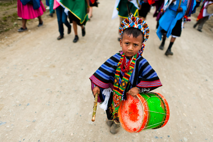 A child from the Kamentsá tribe, wearing a colorful costume, plays drum during the Carnival of Forgiveness, a traditional indigenous celebration in Sibundoy, Colombia.