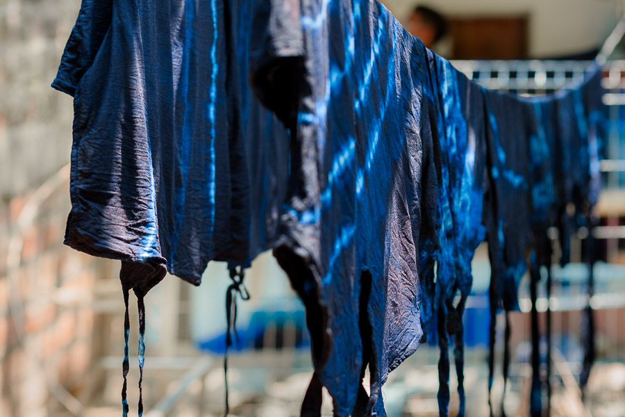 Indigo-dyed clothing, after being processed in the dye bath, are seen hung on a clothesline in an artisanal clothing workshop in Santiago Nonualco, El Salvador.