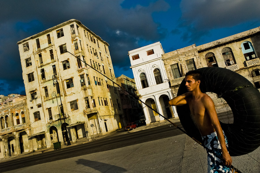 A young Cuban boy goes to fish in Malecon, a promenade and seawall in Havana, Cuba.