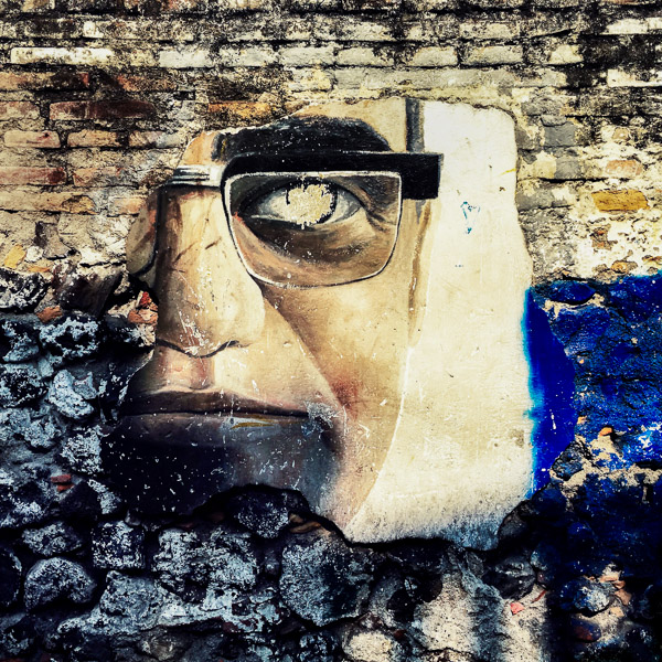 A broken mural depicting Óscar Romero, a former archbishop of San Salvador assassinated in 1980, is seen on the wall in the center of San Salvador, El Salvador.