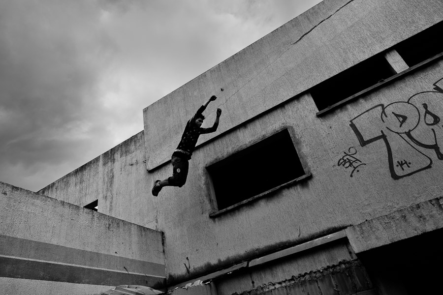 A Colombian parkour athlete jumps from the wall during a free running training session of Plus Parkour team in Bogotá, Colombia.