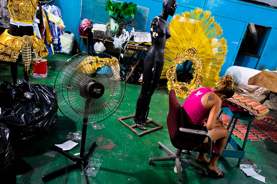 A member of a samba school arranges carnival costumes (fantasias) inside the workshop in Rio de Janeiro, Brazil.
