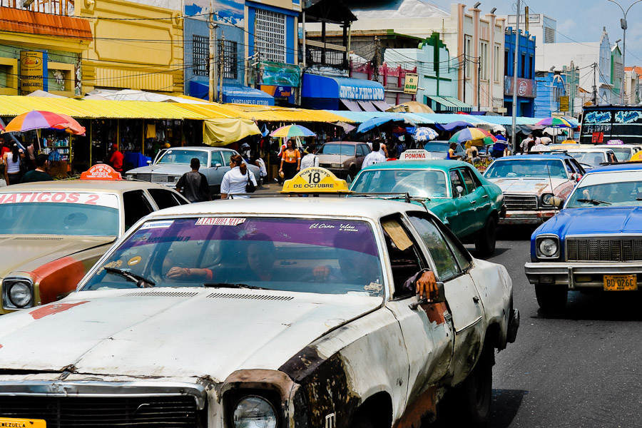 American classic cars from 1970s, used as a shared taxi, passing along the main road in Maracaibo, Venezuela.
