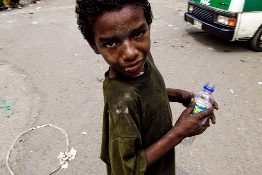 A street kid sniffing the shoe glue. The glue is the cheapest trip available in every Southamerican slum.