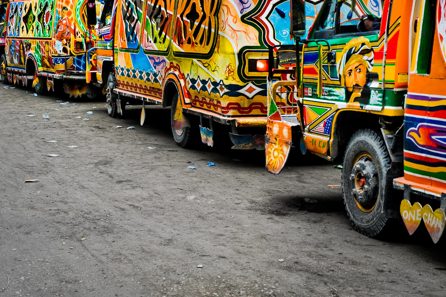 Tap-tap buses passing through the downtown of Port-au-Prince.