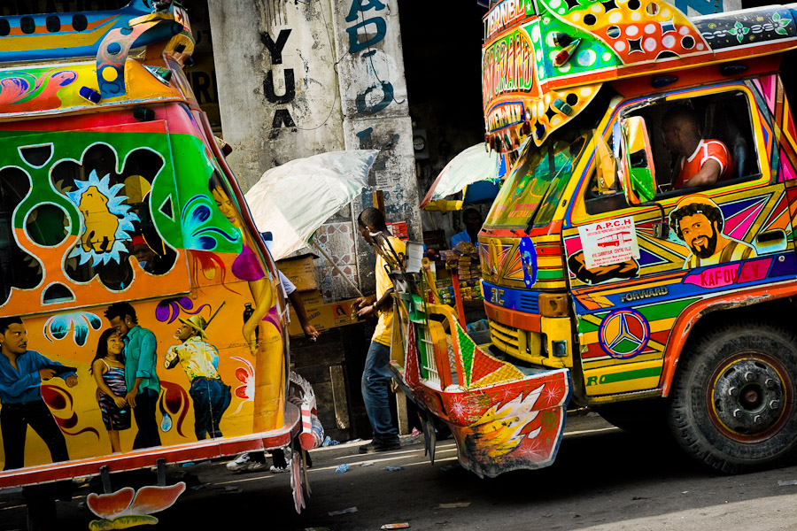 Tap-tap buses waiting to get full and depart for their regular route in the downtown of Port-au-Prince.