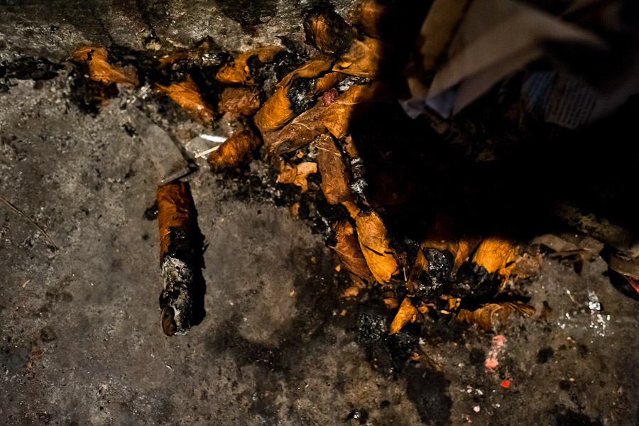 The cigar butts, used for predicting the future, are seen thrown on the ground in the corner of a street fortune telling shop in San Salvador, El Salvador.