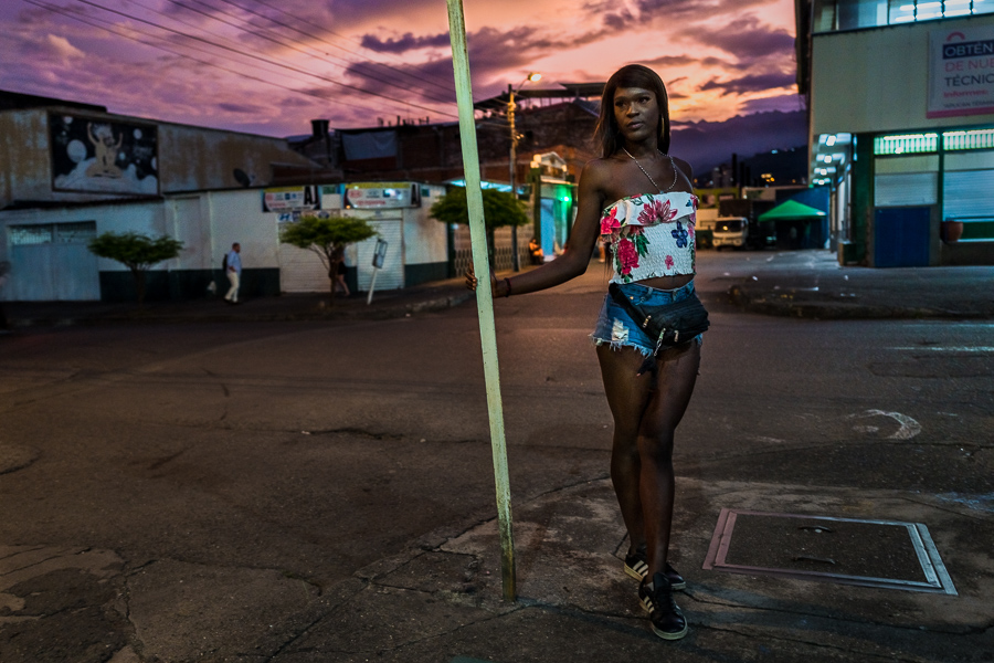 A Colombian transgender woman poses for a picture while waiting for sex service clients in the street in Cali, Colombia.