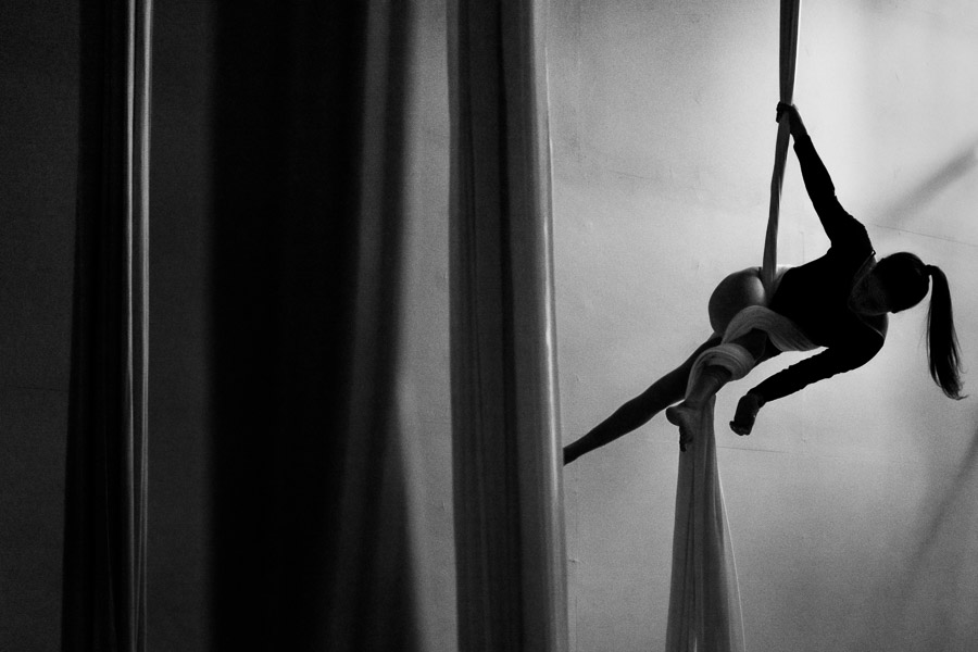A Colombian aerial dancer performs on aerial silks during a training session in a gym in Medellín, Colombia.