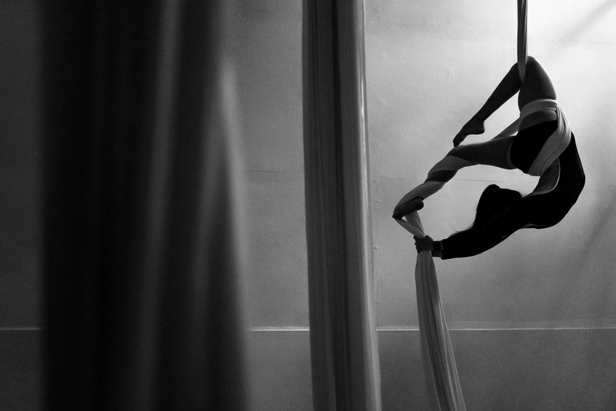 A Colombian aerial dancer shows off her flexibility skills on aerial silks during a training session in a gym in Medellín, Colombia.