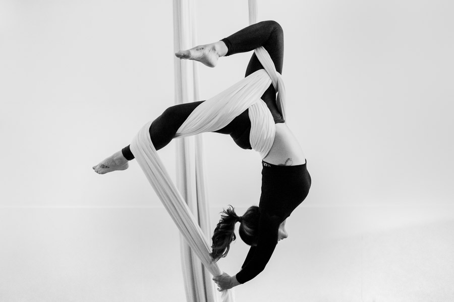 A Colombian aerial dancer performs a wrap trick on aerial silks during a training session in a gym in Medellín, Colombia.