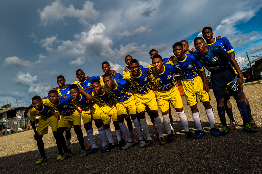 Afro-Colombian football players pose for a group photo before playing a match on a dirt field in Quibdó, Chocó, the Pacific department of Colombia.
