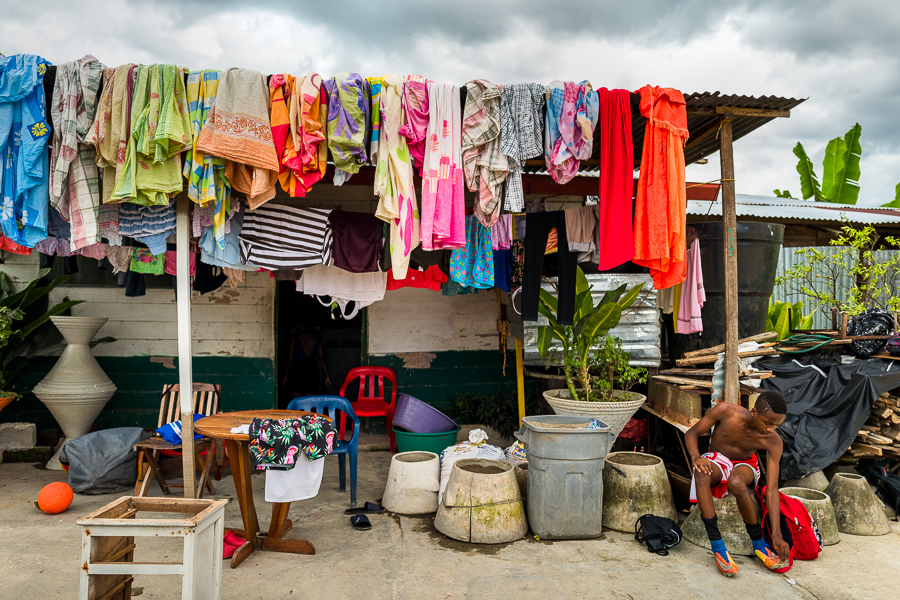 An Afro-Colombian boy wears football boots before performing daily training on a dirt field outside Quibdó, Colombia.