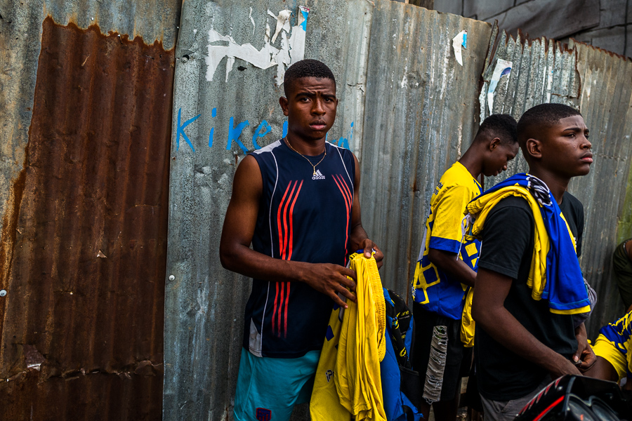 Afro-Colombian boys wear shirts before playing a football match on a dirt field in Quibdó, Chocó, the Pacific department of Colombia.