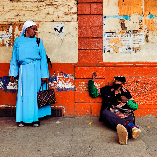 An Afro-Colombian man talks to an Afro-Colombian nun while waiting on a bus station in Santander de Quilichao, Cauca, Colombia.