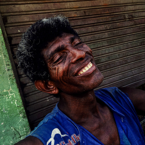 An Afro-Colombian carrier smiles after finishing a whole day work shift at the market of Bazurto in Cartagena, Colombia.