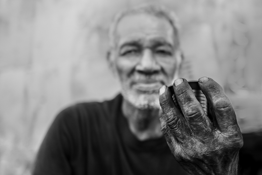 An Afro-Colombian charcoal worker holds a cup of “tinto” (black coffee) in a street market in Barranquilla, Colombia.