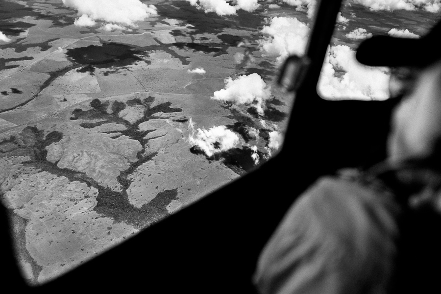 Large expanses of land, covered by Amazonian rainforest, are seen from the cockpit of a Douglas DC-3 aircraft, flying over the remote department of Guainía, Colombia.