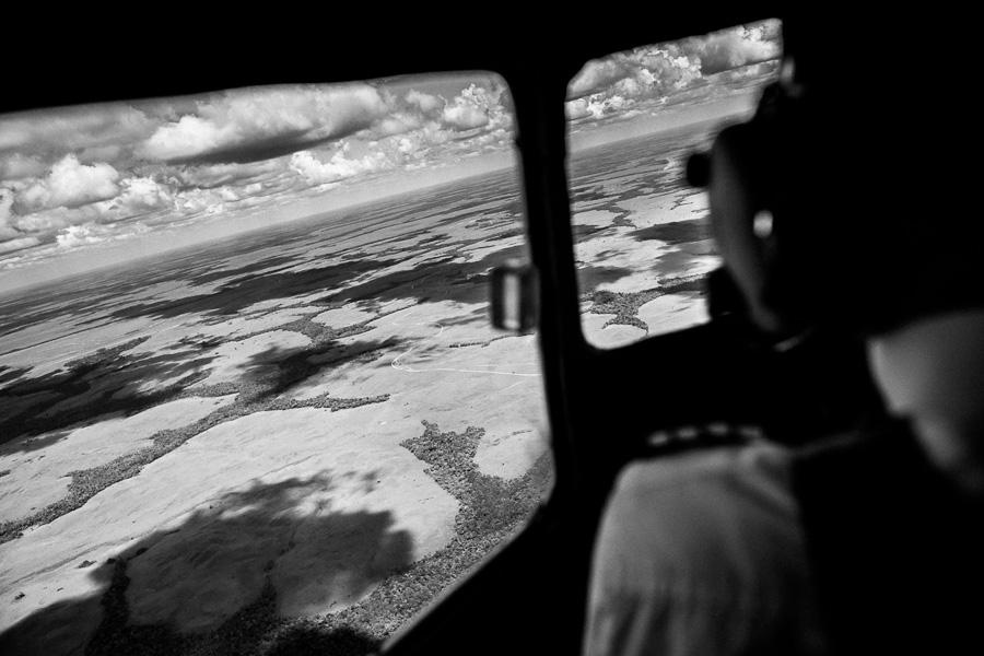 Vast expanses of land, covered by Amazonian rainforest, are seen from the cockpit of a Douglas DC-3 aircraft, flying over the remote department of Guainía, Colombia.