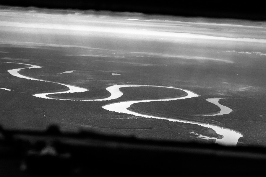 Dense Amazonian rainforest, traversed by rivers and canals, is seen from the cockpit of a Douglas DC-3 aircraft, flying over the remote department of Guainía, Colombia.