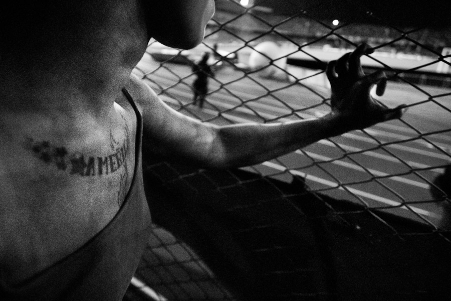 A Colombian girl, having a football fan tattoo on her breast, stands by the fence at the América de Cali football club stadium in Cali, Colombia.