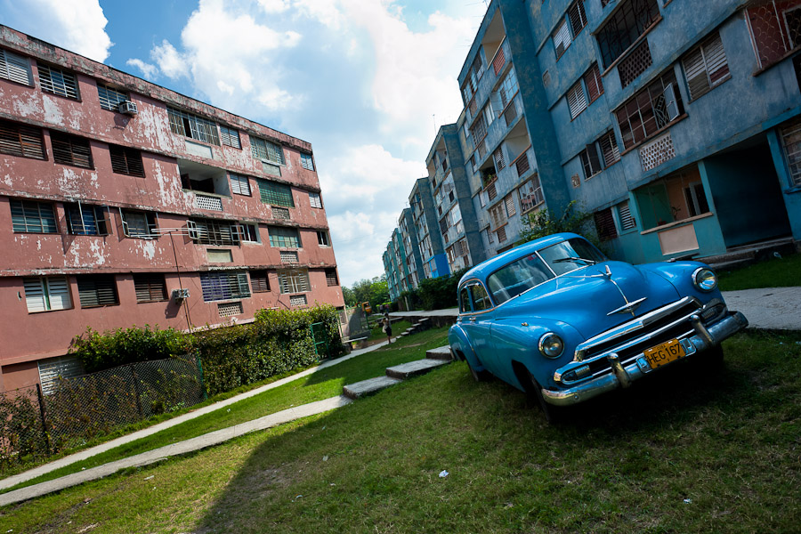 An American classic car is seen parked in front of the apartment block in Bahía, a public housing suburb in the Eastern Havana, Cuba.