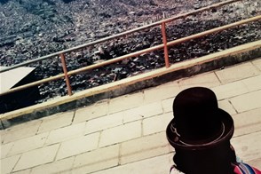 Aymara woman looks down from El Alto (La Paz, Bolivia)