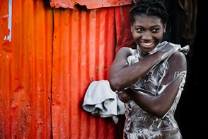 A girl having a bath (Dessalines, Port-au-Prince, Haiti)