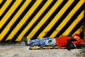 A homeless man sleeps on the street (Bogotá, Colombia)