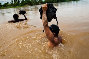 Immigrants cross the river (Rio Seco, Mexico-Guatemala border)