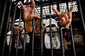 Gang members behind the bars (San Salvador, El Salvador)