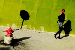 A woman passing by a hydrant (Bogotá, Colombia)